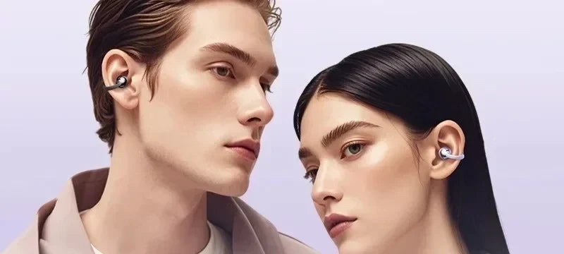 A couple wearing NuveSleep DreamBuds 2.0 open-ear clip earbuds, resting on the outer ear