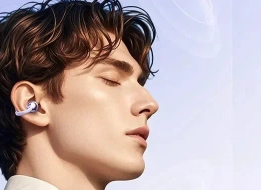 Man asleep on his side wearing NuveSleep DreamBuds 2.0 open-ear earbuds